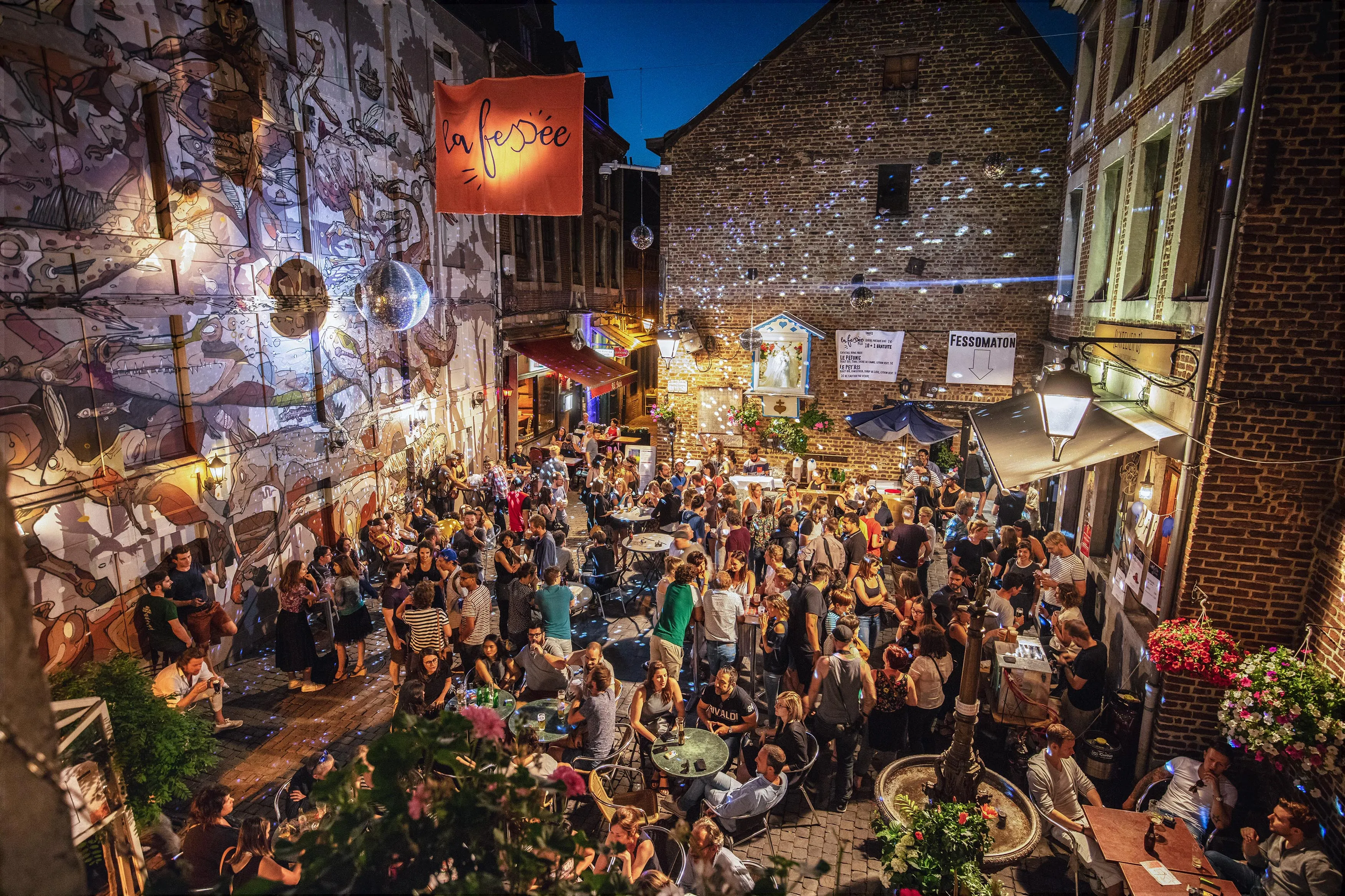Lively courtyard at La Fessée bar, Liège